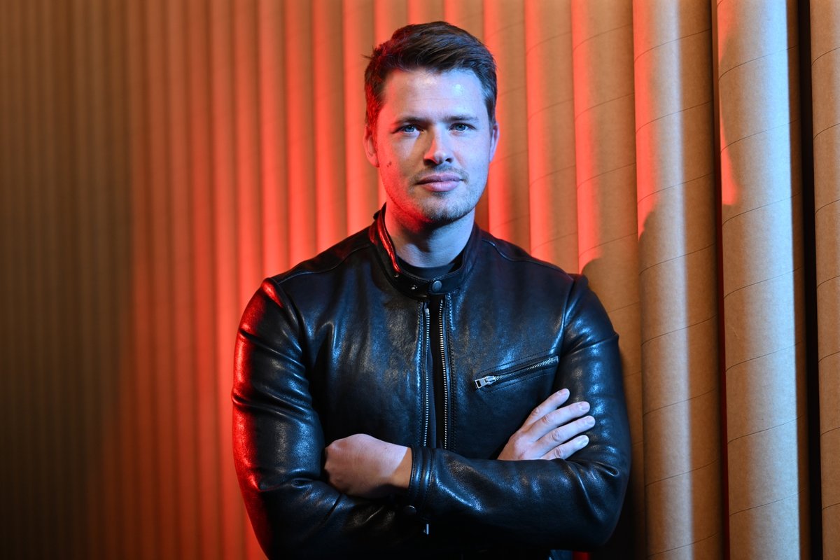 James Sackl, Melbourne founder, in a black leather jacket against a red-lit ribbed backdrop — portrait for the Golden Age project.